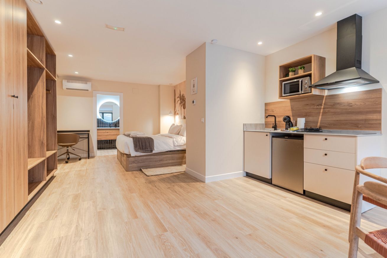 A modern kitchen with wooden cabinets, a microwave, and a dishwasher.