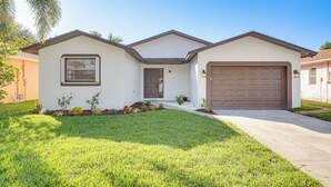 A single-story house with a garage, a front door, and a small porch area. - Walk to Shops & Eats, 3 Mi to Beach! Hollywood Gem (Hollywood)