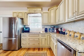 A kitchen with light-colored cabinets, a stainless steel refrigerator, a dishwasher, and a granite countertop. - Mtn Views! Romantic Rural Retreat in Seymour (Seymour)