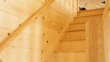 A wooden staircase with a handrail and a landing area.