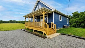 A two-story house with a porch, a front door, and a small front yard. - Sapphire Cabin, Hot Tub, Fire Pit & Bourbon Trail, Sleeps 6 (Willisburg)