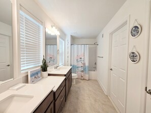 A bathroom with a double sink, a toilet, a shower, and a bathtub. - Rehoboth Beach Vacation Rentals: Luxury House at Arbor Lyn w Ent (Rehoboth Beach)