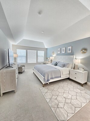 A bedroom with a large bed, bedside tables, a dresser, and a ceiling light. - Rehoboth Beach Vacation Rentals: Luxury House at Arbor Lyn w Ent (Rehoboth Beach)