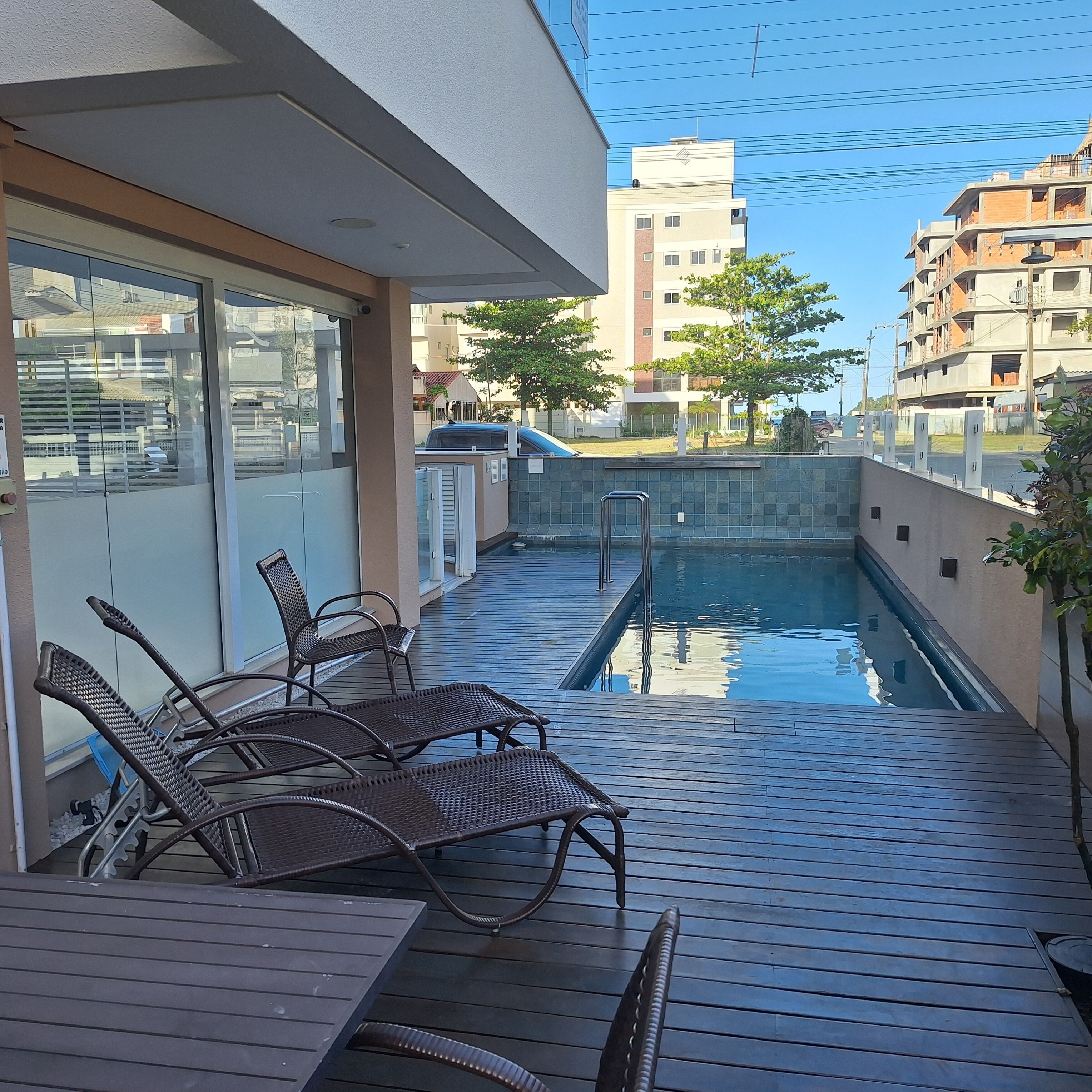 A poolside area with lounge chairs and a small pool.