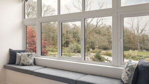 A room with a large window overlooking a garden. - The Lookout With 1 Bedrooms and 1 Bathrooms (Grange-over-Sands)