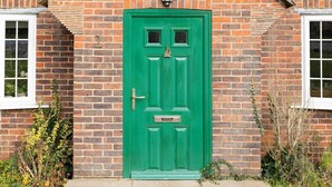 A brick house with a green door, a small porch, and a window on the left. - Rural House With Swimming Pool and Gardens (Chichester)