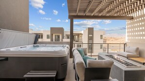 A balcony with a hot tub, outdoor seating, and a view of the desert. - Weekend Vibes 5 Bedroom Townhouse (St. George)