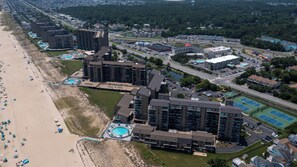 An aerial view of a coastal hotel with multiple high-rise buildings, a beach, and a parking lot. - 908 Dover - Sea Colony East (Bethany Beach)