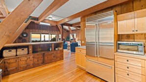 A kitchen with wooden cabinets, a stainless steel refrigerator, and a microwave. - 25% Off Sept 7-9, On The Sand Perfect 4 Families! (Ventura)