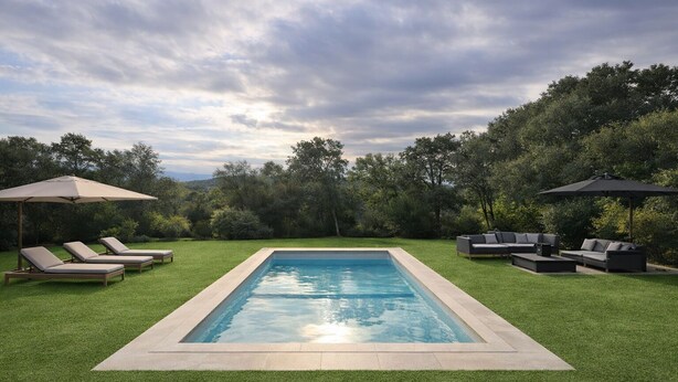 A rectangular swimming pool with a surrounding grassy area, two lounge chairs, and two umbrellas. - Villa 8 people - Peace & comfort (Ghisonaccia)