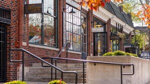 A brick building with a sign reading 'Haven's' and a staircase leading to the entrance. - Music Row Bliss • Pool, Rooftop + Free Parking (Nashville)