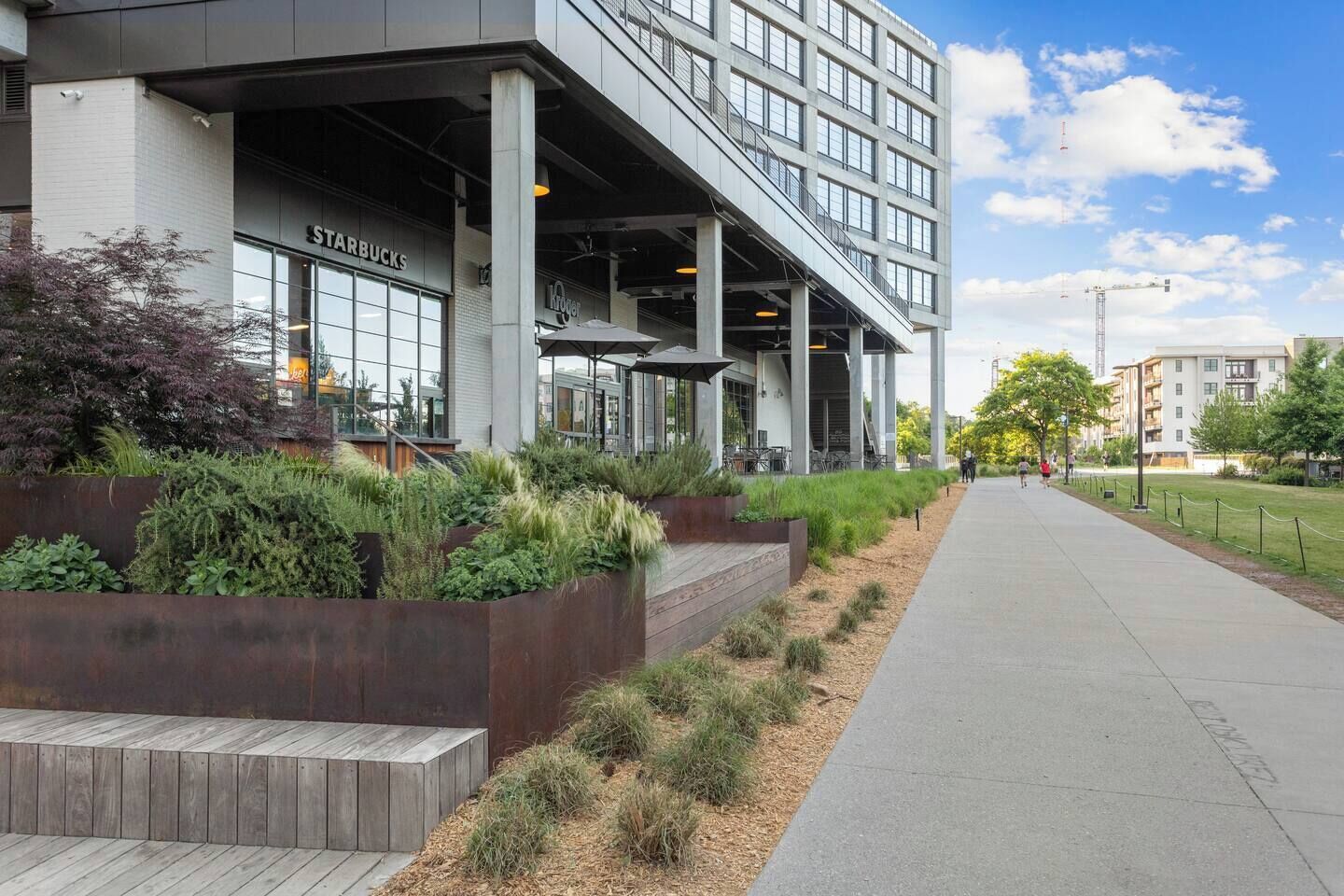 A modern building with a Starbucks and a large open space with seating.
