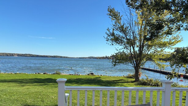 A white deck with a bench and a view of a lake. - Lakefront 2-bedroom home with dock and AC, minutes from Chautauqua, Sleeps 6 (Mayville)