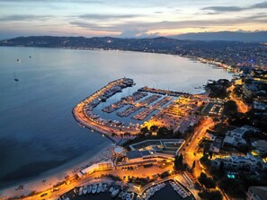 An aerial view of a marina with boats docked, a parking area, and buildings along the waterfront. - Cannes central Rue d'Antibes wide 1 BDR w/ terrace - quiet in green scenery (Cannes)