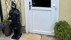 A white door with a glass panel, a small mailbox, and a decorative metal gate with a statue. - The Old Hanging Gate Inn built in the early 1800s as a former coach house inn. (Telford)