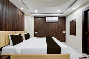 A modern hotel room with a large bed, wooden panel walls, an air conditioning unit, and a marble floor. - Hotel O Barasat Government College (Barasat)