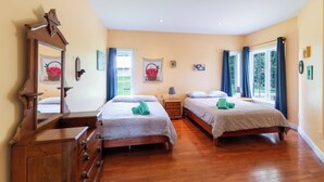 Un dormitorio con dos camas, muebles de madera y un espejo grande.