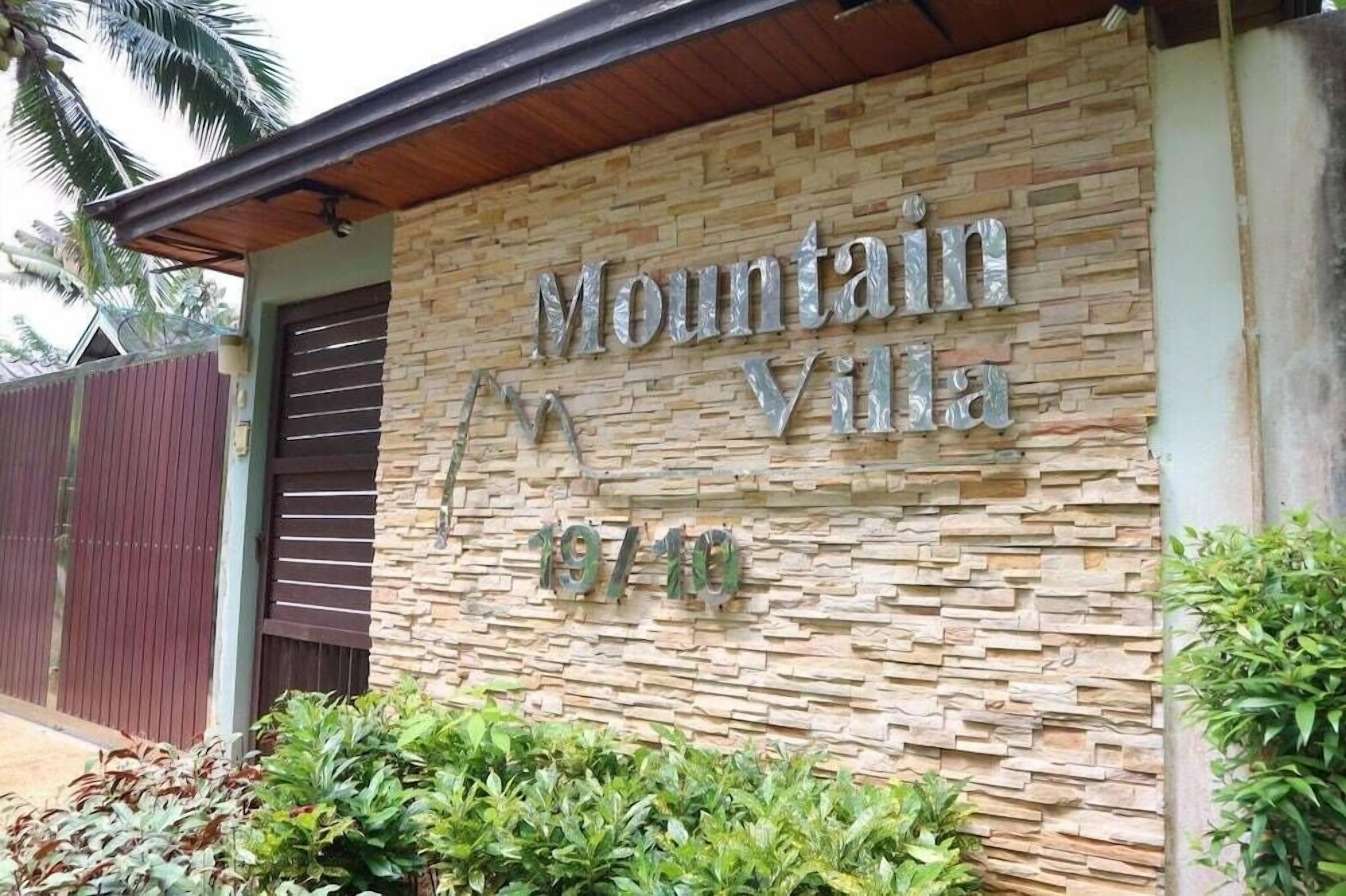A building with a stone facade and a sign that reads "Mountain Villa 1979".