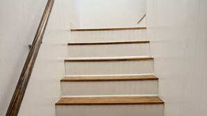A staircase with wooden steps and white walls. - Cozy Remodel 2 Story w/ King Bed / W/D / BBQ Patio (El Paso)