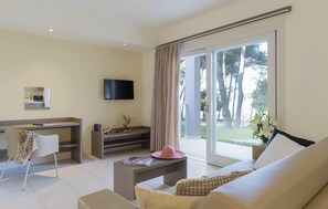 A modern living room with a sofa, a coffee table, a TV, and a sliding glass door to a balcony. - Stunning apartment in Biograd with sauna (Biograd)