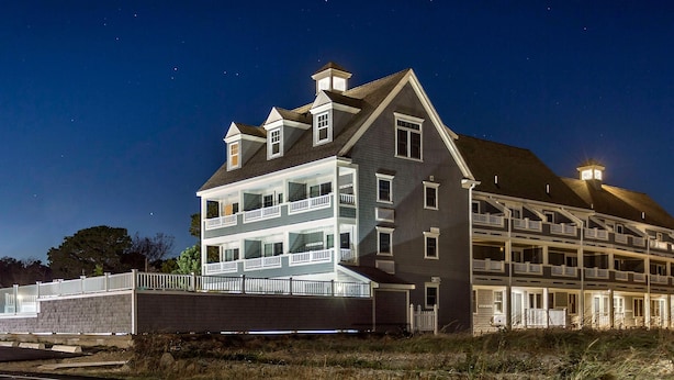 A large, multi-story hotel with balconies and a prominent roofline. -  Awesome Ocean Front Vacation Condo on the Cape in MA (Dennis)