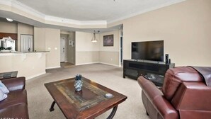 A spacious living room with a ceiling fan, a TV, a fireplace, and a coffee table. - this is very basic. (Jacksonville)