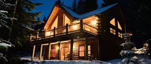A log cabin with a balcony and large windows, surrounded by snow. - Perfect 3-bedroom cabin in tranquil Crescent Lake Oregon with AC (Crescent Lake Junction)