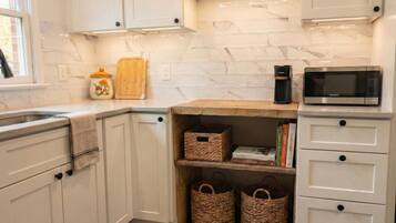 Fridge, microwave, coffee/tea maker, cookware/dishes/utensils