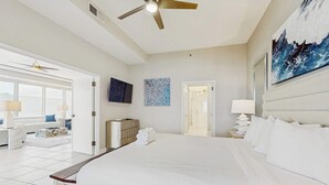 A spacious bedroom with a large bed, a ceiling fan, and a view of the living area. - Exclusive Gulf view 3BR, pool & tennis (Miramar Beach)
