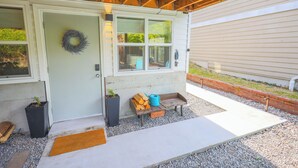 A house with a front door, a wreath, a bench with firewood, and a hose. - Countryside Calm, New Reno, Spa Bathroom, Beautiful Area Near Alki Beach (Seattle)