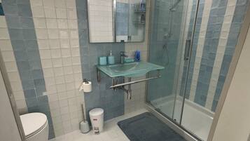 Een douche, een haardroger, een bidet, handdoeken