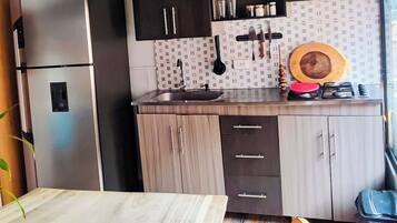 Fridge, coffee/tea maker, electric kettle, cookware/dishes/utensils
