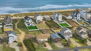 Ein Küstenwohngebiet mit Häusern, einem Strand und einer Straße.