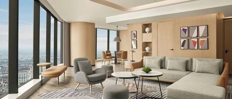 Una sala de estar moderna con un sofá, sillones, una mesa de centro y una alfombra.