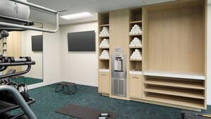 A gym with exercise equipment, a hydration station, and a mirror. - Towneplace Suites By Marriott Montreal Airport (Dorval)