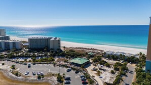 An aerial view of a coastal hotel with a beach, parking area, and ocean views. - Seaside Oasis - Sleeps 17 (Panama City)
