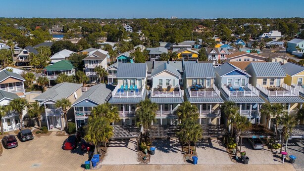A coastal residential area with multiple two-story houses featuring balconies and a sandy beach in the foreground. - Seaside Oasis - Sleeps 17 (Panama City)