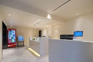 A reception area with a counter, a digital screen, a refrigerator, and a vending machine. - Yashi Mountain Stream · Children's Swimming Pool Designer Parent Child Vacation Scenic Stay (Hangzhou)