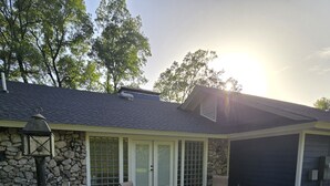 A house with a stone exterior, a covered patio with outdoor furniture, and a stone wall surrounding the patio area. - Charming Blue Horizen 4-bedroom house with AC in quite neighborhood in Malvern (Malvern)