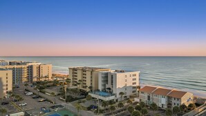A coastal hotel with multiple buildings, a parking lot, and a pool area. - Beachfront Townhome With Instant Access to Beach Beachside Kisses by Avantstay (Fort Walton Beach)