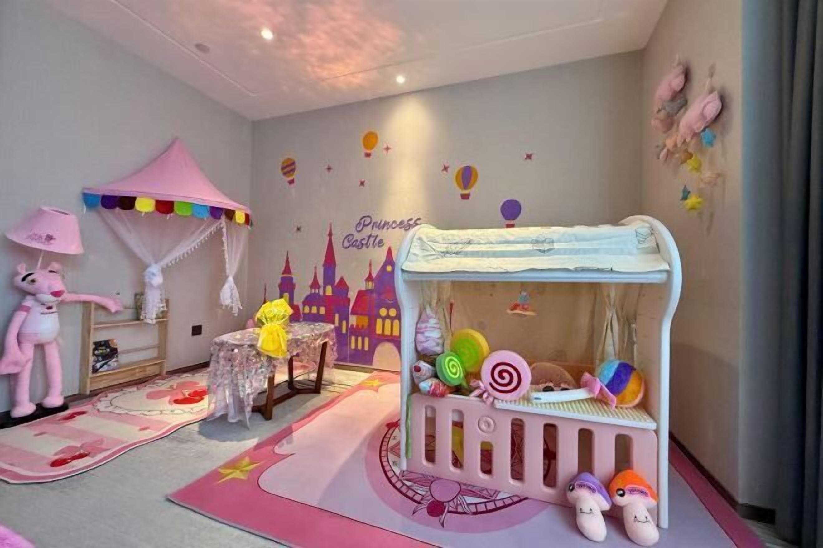 A child's bedroom with a pink canopy bed, a castle mural, and a plush toy.