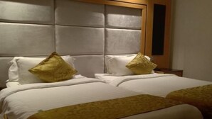 A hotel room with a large bed, two pillows, and a headboard. - Al Rayyan Tower (Jeddah)