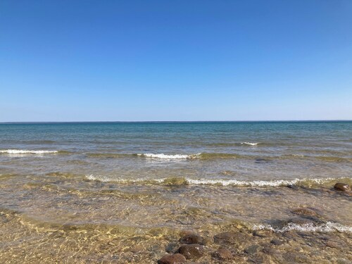 Home on Lake Huron with sandy beach and beautiful yards in Cheboygan, Michigan 