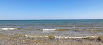 Home on Lake Huron with sandy beach and beautiful yards in Cheboygan, Michigan 