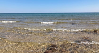 Home on Lake Huron with sandy beach and beautiful yards in Cheboygan, Michigan