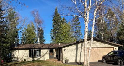 Home on Lake Huron with sandy beach and beautiful yards in Cheboygan, Michigan