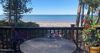 Home on Lake Huron with sandy beach and beautiful yards in Cheboygan, Michigan