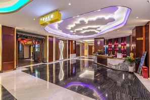 A hotel lobby with a reception desk, a digital sign, and a modern ceiling design. - Chengde Hotel (Mountain Resort) (Chengde)