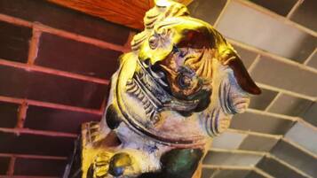 A detailed sculpture of a mythical creature, possibly a dragon, with intricate carvings and a prominent horn.