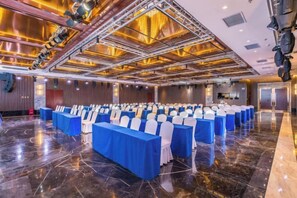 A conference room with rows of tables and chairs, a polished floor, and a high ceiling with lighting fixtures. - Chengde Hotel (Mountain Resort) (Chengde)